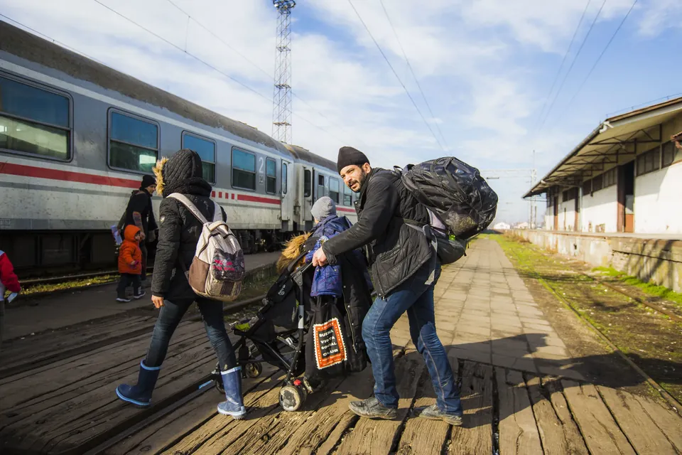 Refugees board a train in Šid, Serbia, bound for the Croatian border